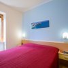 Camera da letto con letto matrimoniale e pareti blu e bianche.
